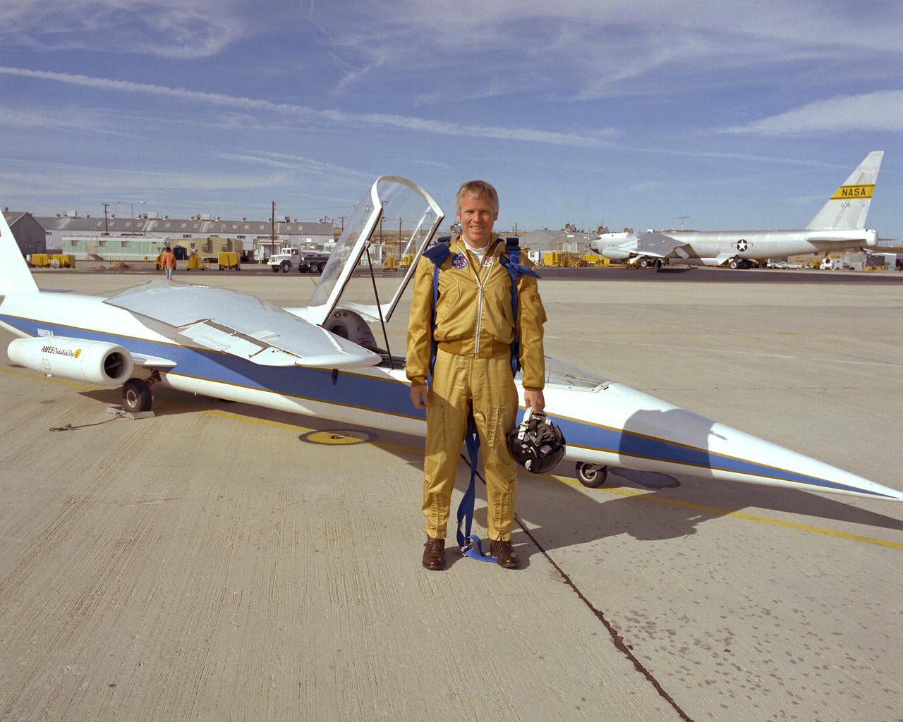 Research pilot Richard E. Gray, standing in front of the AD-1 Oblique Wing research aircraft.
