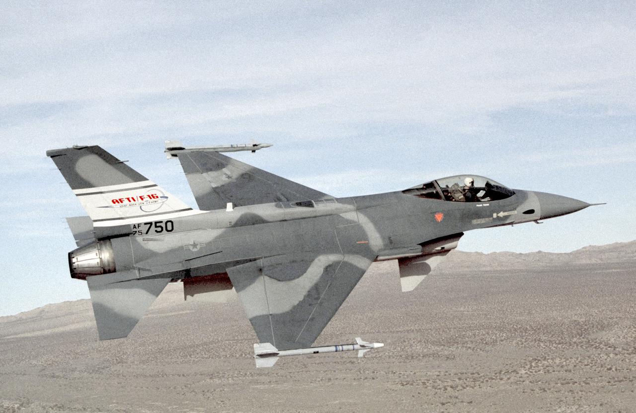 This photo depicts the AFTI F-16 in the configuration used midway through the program. The sensor pods were added to the fuselage, but the chin canards remained in place. Painted in non-standard gray tones, it carried Sidewinder air-to-air missles on its wingtips.