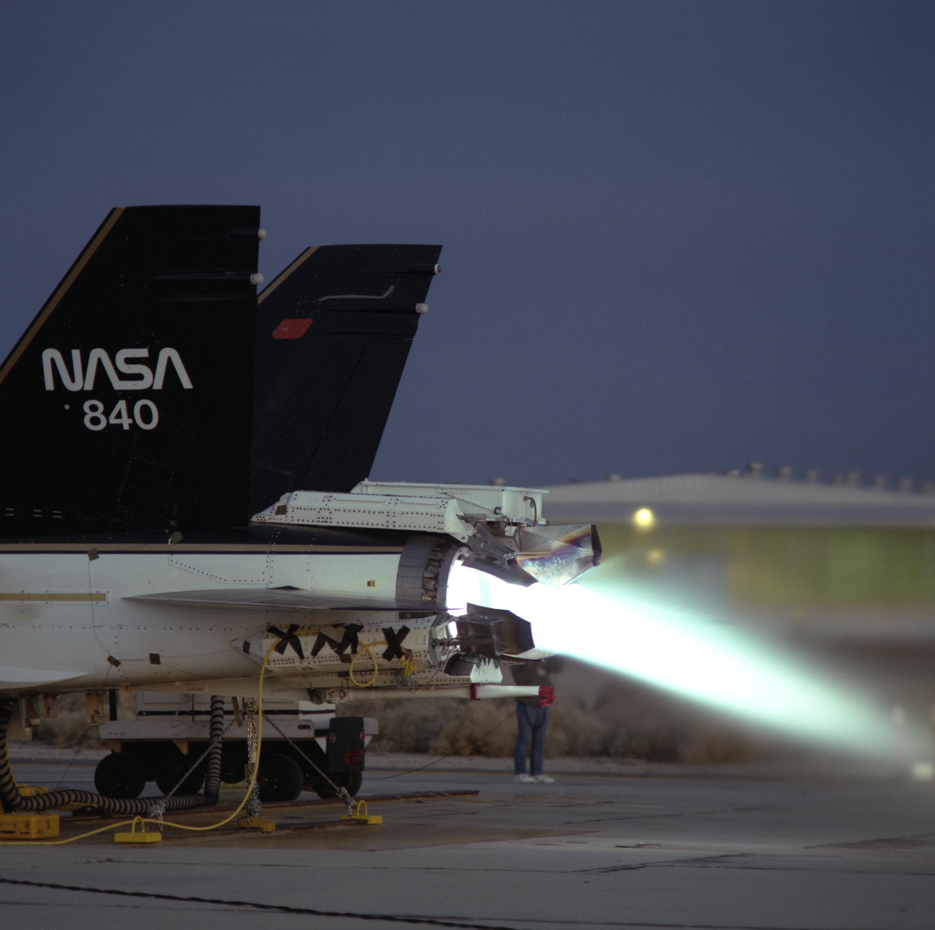 Aircraft performs a thrust vectoring test in afterburner in 1991, while anchored to the ground.