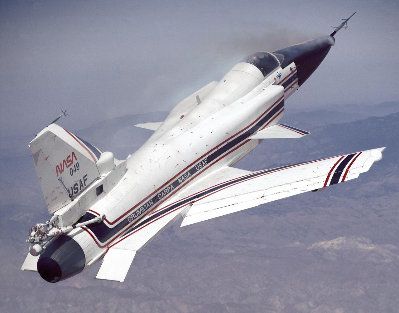 This photo shows the X-29 during a 1991 research flight. Smoke generators in the nose of the aircraft were used to help researchers see the behavior of the air flowing over the aircraft. The smoke here is demonstrating forebody vortex flow. This mission was flown September 10, 1991, by NASA research pilot Rogers Smith.