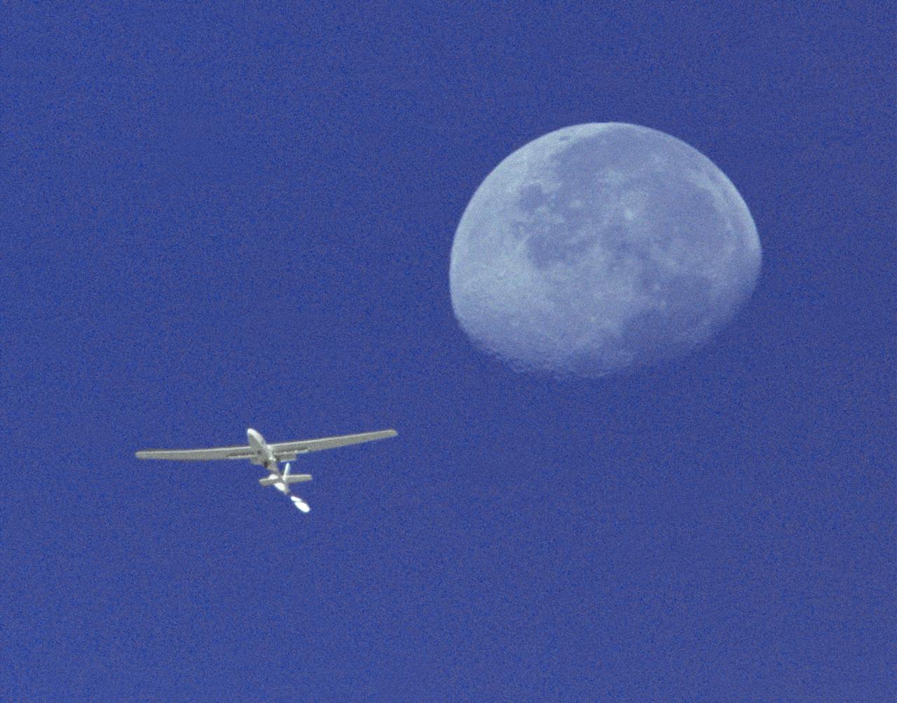 The Perseus A, a remotely-piloted, high-altitude research aircraft, is seen here framed against the moon and sky during a research mission at the Dryden Flight Research Center, Edwards, California in August 1994.
