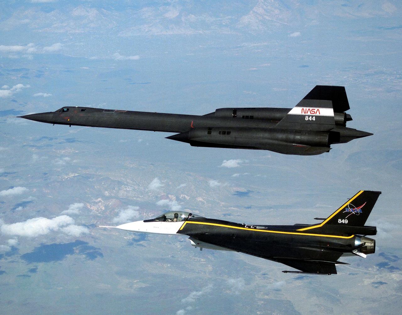 The single-seat F-16XL, NASA 849, joins up with an SR-71A, NASA 844, as crews set up for one of the flights in the recent sonic boom research program conducted by the Dryden Flight Research Center, Edwards, California.  During the missions, the F-16XL probed the shockwaves generated by the SR-71, while at lower altitudes sensors on an F-18 and on a YO-3A, and also on the ground, recorded data from the same shockwave.