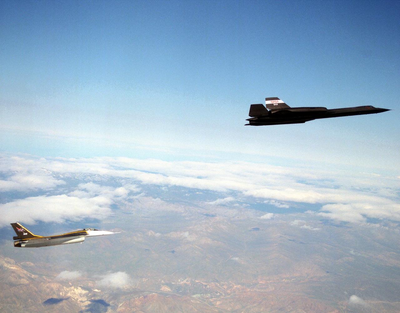 The single-seat F-16XL, NASA 849, joins up with an SR-71A, NASA 844, as crews set up for one of the flights in the recent sonic boom research program conducted by the Dryden Flight Research Center, Edwards, California.  During the missions, the F-16XL probed the shockwaves generated by the SR-71, while at lower altitudes sensors on an F-18 and on a YO-3A, and also on the ground, recorded data from the same shockwave.