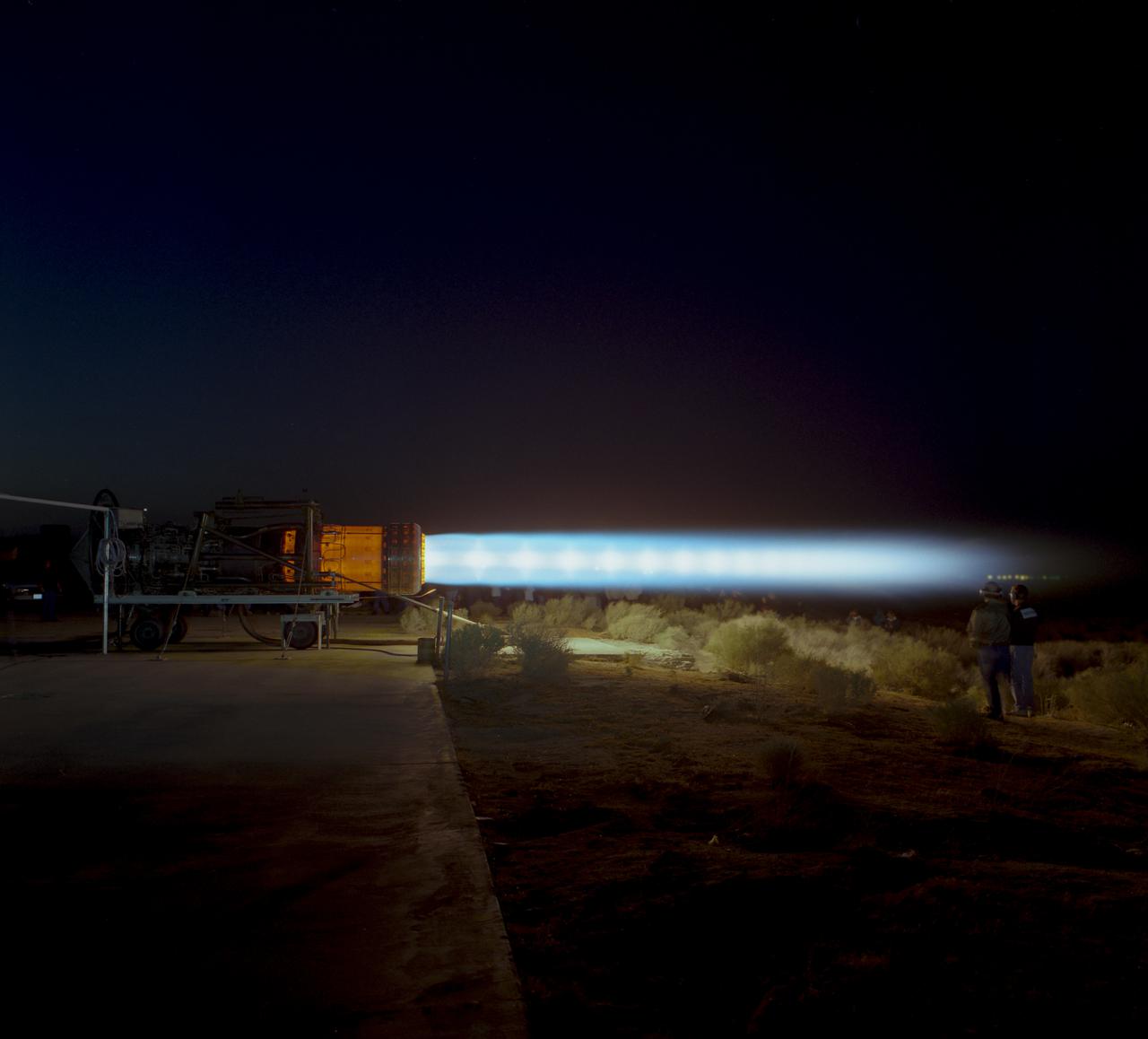 A J58 turbojet used in Lockheed SR-71s which NASA flew, during an engine run. The engine, anchored to the ground, is in full afterburner and parts of the engine are glowing.