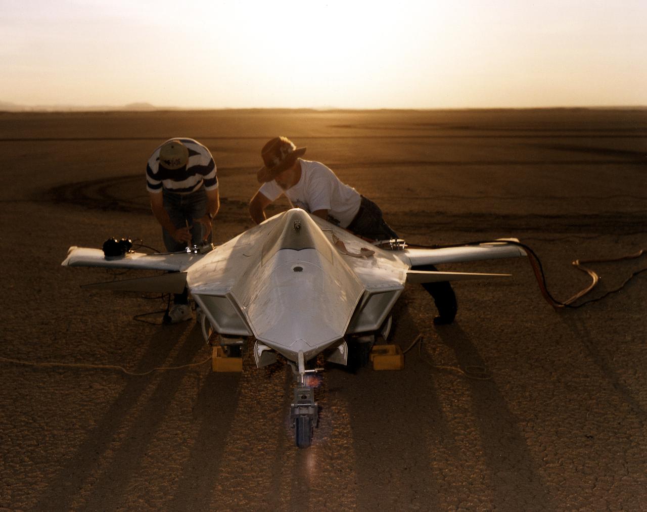 As the sun creeps above the horizon of Rogers Dry Lake at NASA's Dryden Flight Research Center, Edwards, California, technicians make final preparations for the first flight of the X-36 Tailless Fighter Agility Research Aircraft.