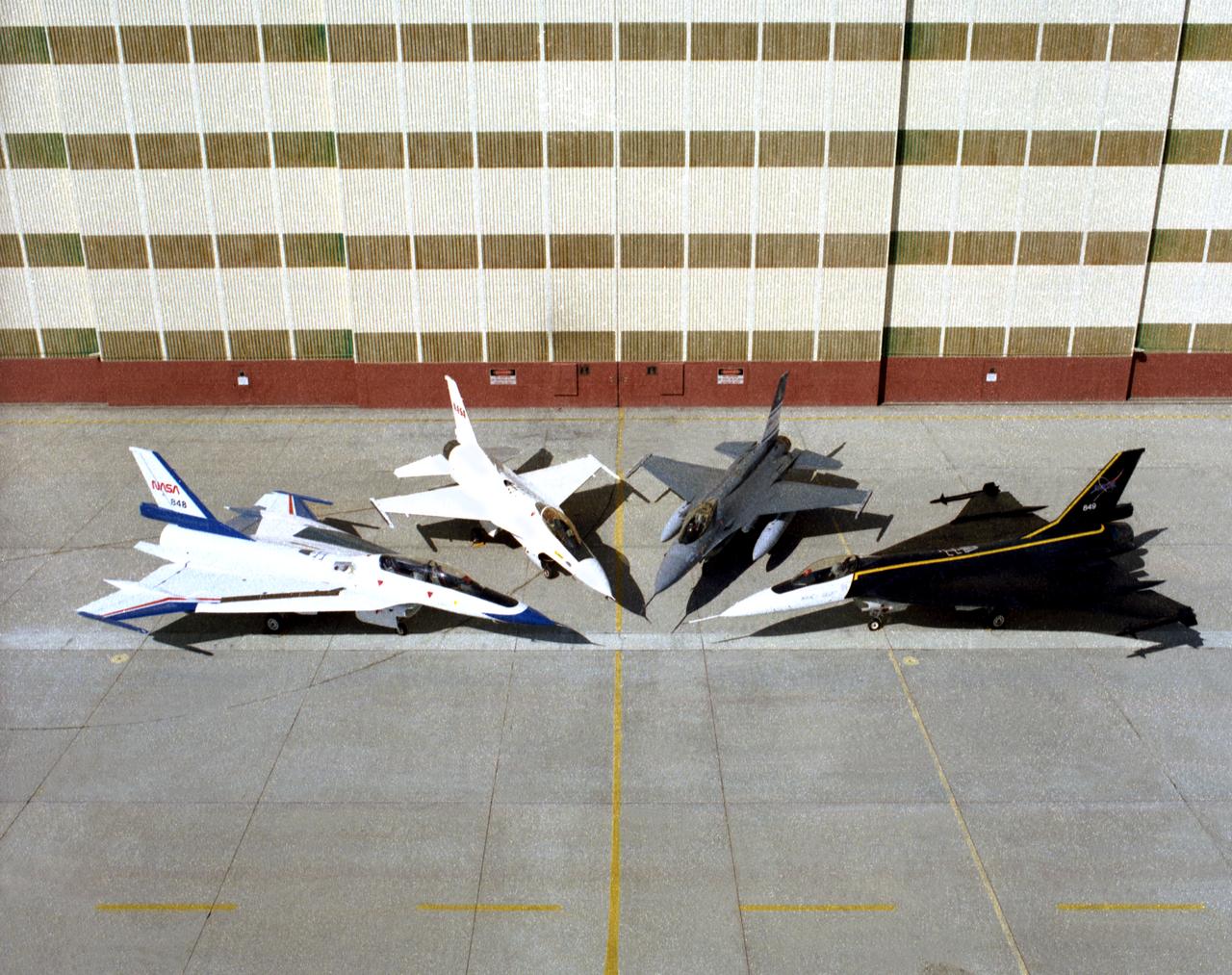 Four different versions of the F-16 were used by Dryden in the 1990s. On the left and right sides are two F-16XLs. On the left is the F-16XL #2 (NASA 848), which is the two-seat version, used for advanced laminar flow studies until late 1996. On the right is the single-seat F-16XL #1 (NASA 849), used for laminar flow research and sonic boom research. (Laminar flow refers to smooth airflow over a wing, which increases lift and reduces drag compared to turbulent airflow). Between them at center left is an F-16A (NASA 816), the only civilian operated F-16. Next to it at center right is the U.S. Air Force Advance Fighter Technology Integration (AFTI) F-16, a program to test new sensor and control technologies for future fighter aircraft. Both F-16XLs are in storage at Dryden. The F-16A was never flown at Dryden, and was parked by the entrance to the center. The AFTI F-16 is in the Air Force Museum.