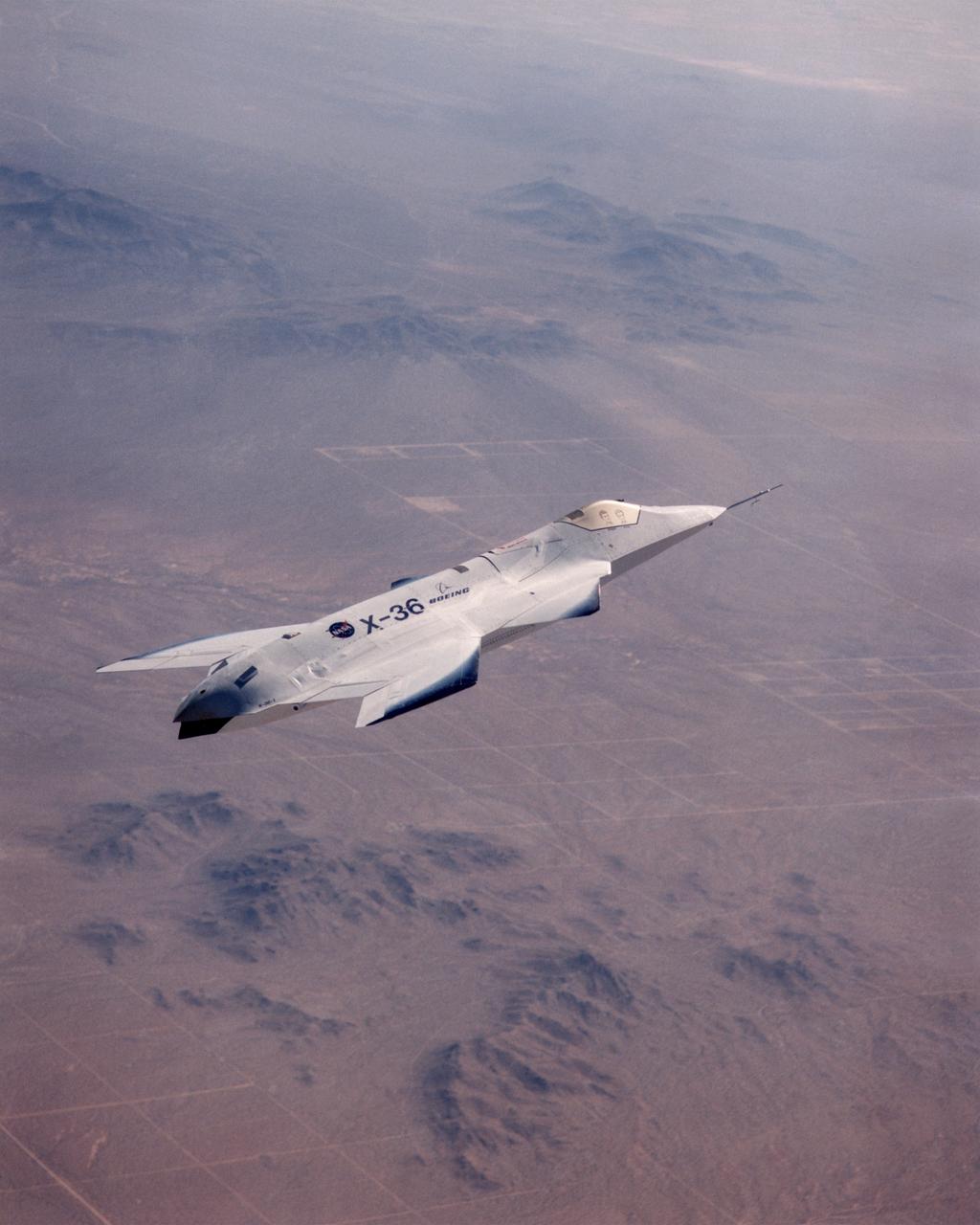 The X-36 technology demonstrator shows off its distinctive shape as the remotely piloted aircraft flies a research mission over the Southern California desert on October 30, 1997.