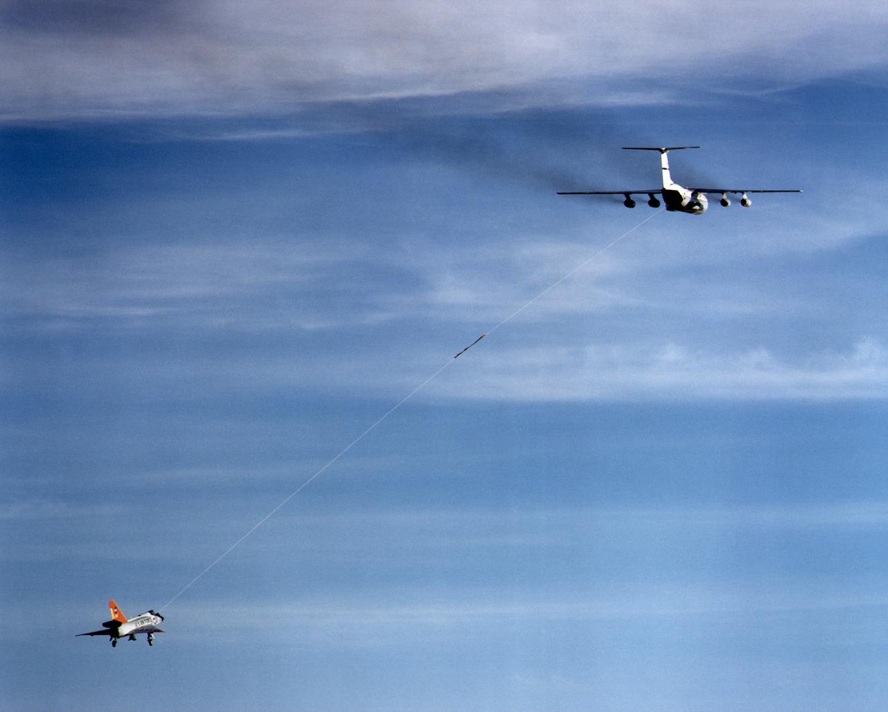 Eclipse project QF-106 and C-141A climbs out under tow on first tethered flight December 20, 1997