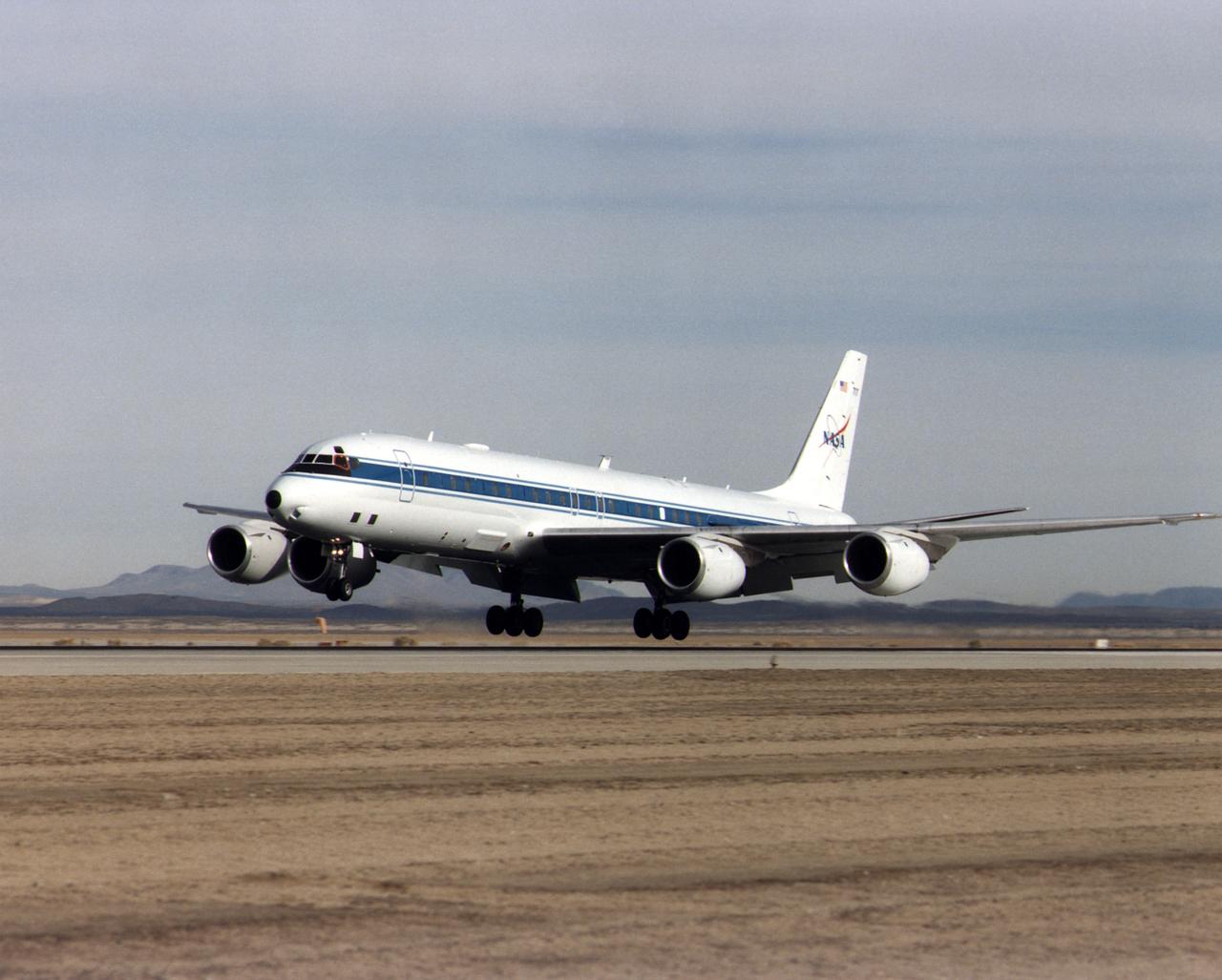 NASA's DC-8 Airborne Science platform landed at Edwards Air Force Base, California, to join the fleet of aircraft at NASA's Dryden Flight Research Center. The white aircraft with a blue stripe running horizontally from the nose to the tail is shown with its main landing gear just above the runway. The former airliner is a "dash-72" model and has a range of 5,400 miles. The craft can stay airborne for 12 hours and has an operational speed range between 300 and 500 knots. The research flights are made at between 500 and 41,000 feet. The aircraft can carry up to 30,000 lbs of research/science payload equipment installed in 15 mission-definable spaces.