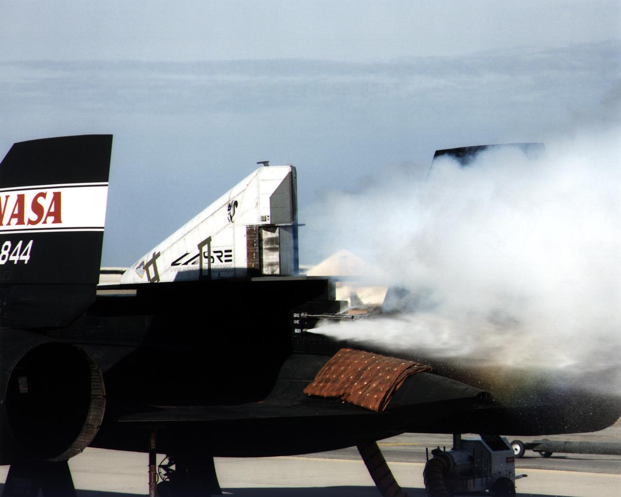 This photograph shows a ground cold flow test of the linear aerospike rocket engine mounted on the rear fuselage of an SR-71.