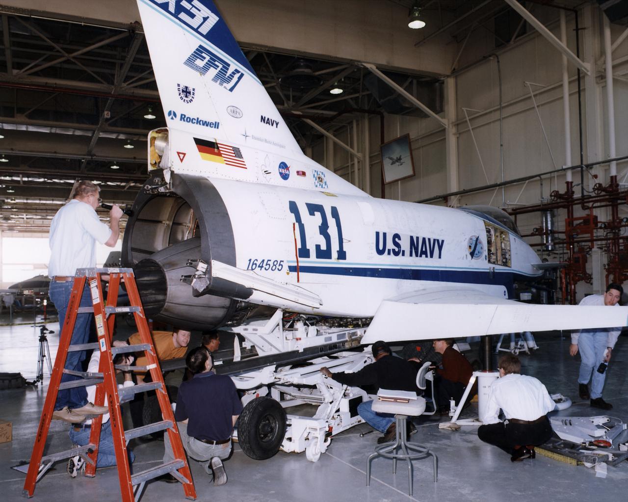 X-31 team members perform an engine fit check on the X-31 Enhanced Fighter Maneuverability demonstrator aircraft in a hangar at the Dryden Flight Research Center, Edwards, California.