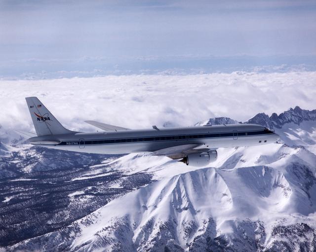 DC-8 Airborne Laboratory in flight over snow-capped Sierra Nevada mountain range