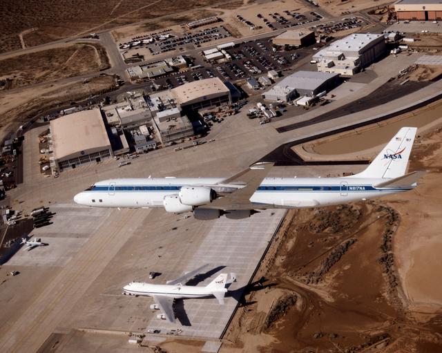 NASA image: DC-8 Airborne Laboratory in flight over NASA Dryden center with SCA 747 on ramp
