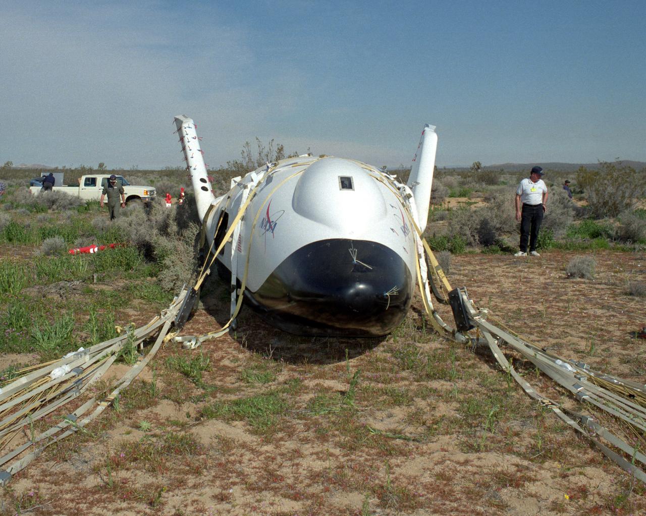 Crew members surround the X-38 lifting body research vehicle after a successful test flight and landing in March 1998. The flight was the first free flight for the vehicle and took place at the Dryden Flight Research Center, Edwards, California.