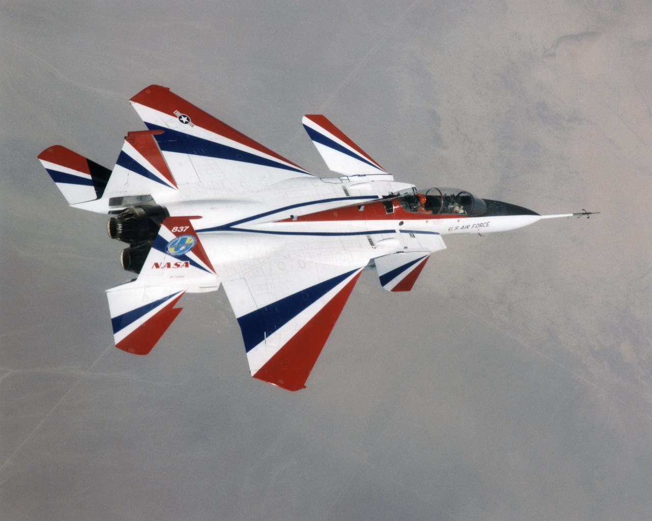 The F-15 ACTIVE in flight above the Mojave desert on April 14, 1998. The overhead shot shows the aircraft's striking red and while paint scheme/ The large forward canards are actually the tail surfaces from an F-18.