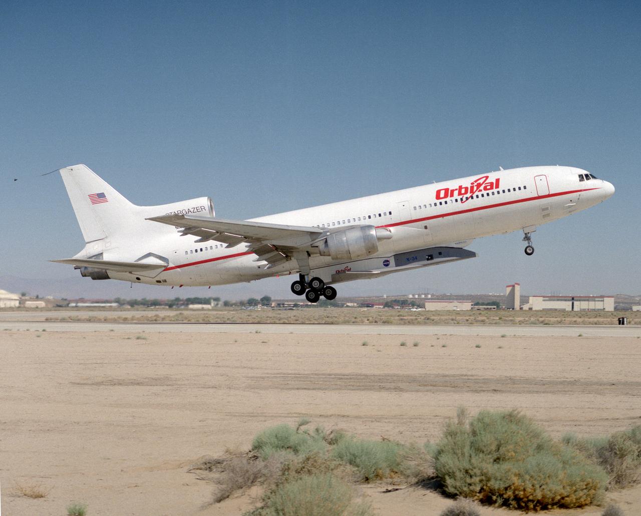 X-34 mated to modified L-1011 during takeoff on first captive carry flight