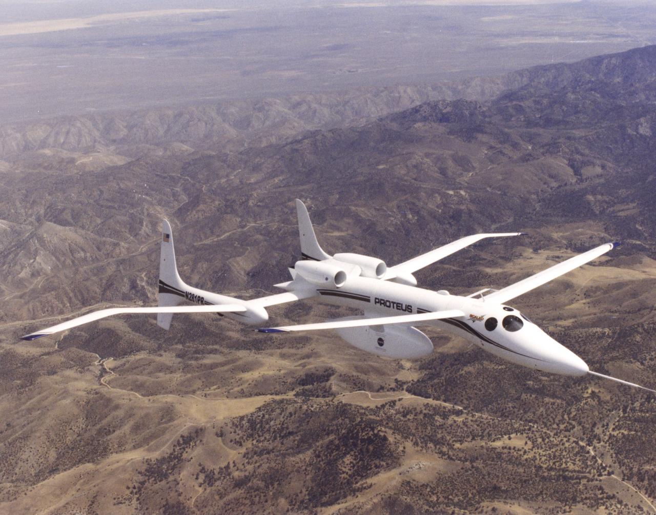 The unusual design of the Proteus high-altitude aircraft, incorporating a gull-wing shape for its main wing and a long, slender forward canard, is clearly visible in this view of the aircraft in flight over the Mojave Desert in California.