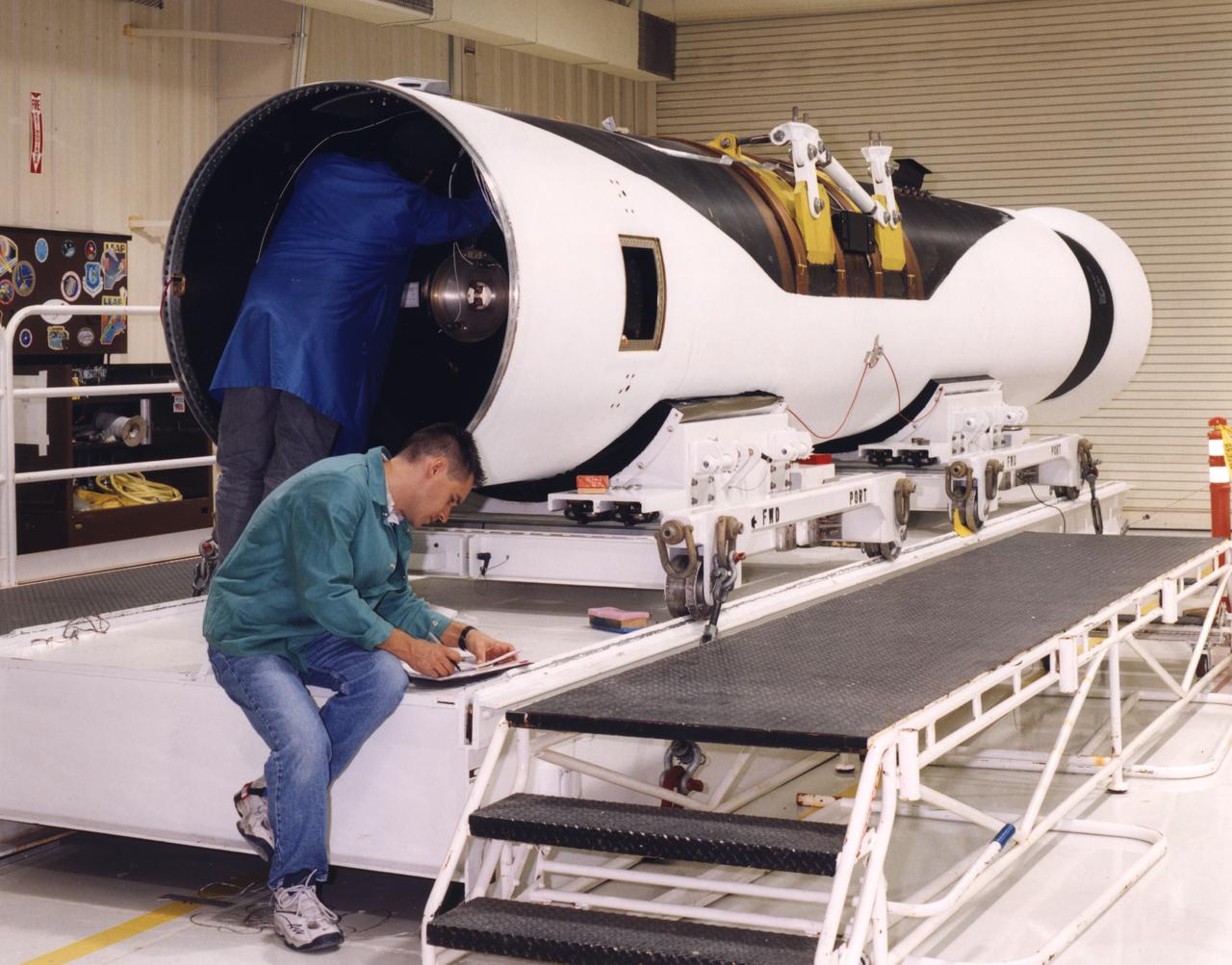 Technicians prepare a Pegasus rocket booster for flight tests with the X-43A "Hypersonic Experimental Vehicle," or "Hyper-X." The X-43A, which will be attached to the Pegasus booster and drop launched from NASA's B-52 mothership, was developed to research dual-mode ramjet/scramjet propulsion system at speeds from Mach 7 up to Mach 10 (7 to 10 times the speed of sound, which varies with temperature and altitude).