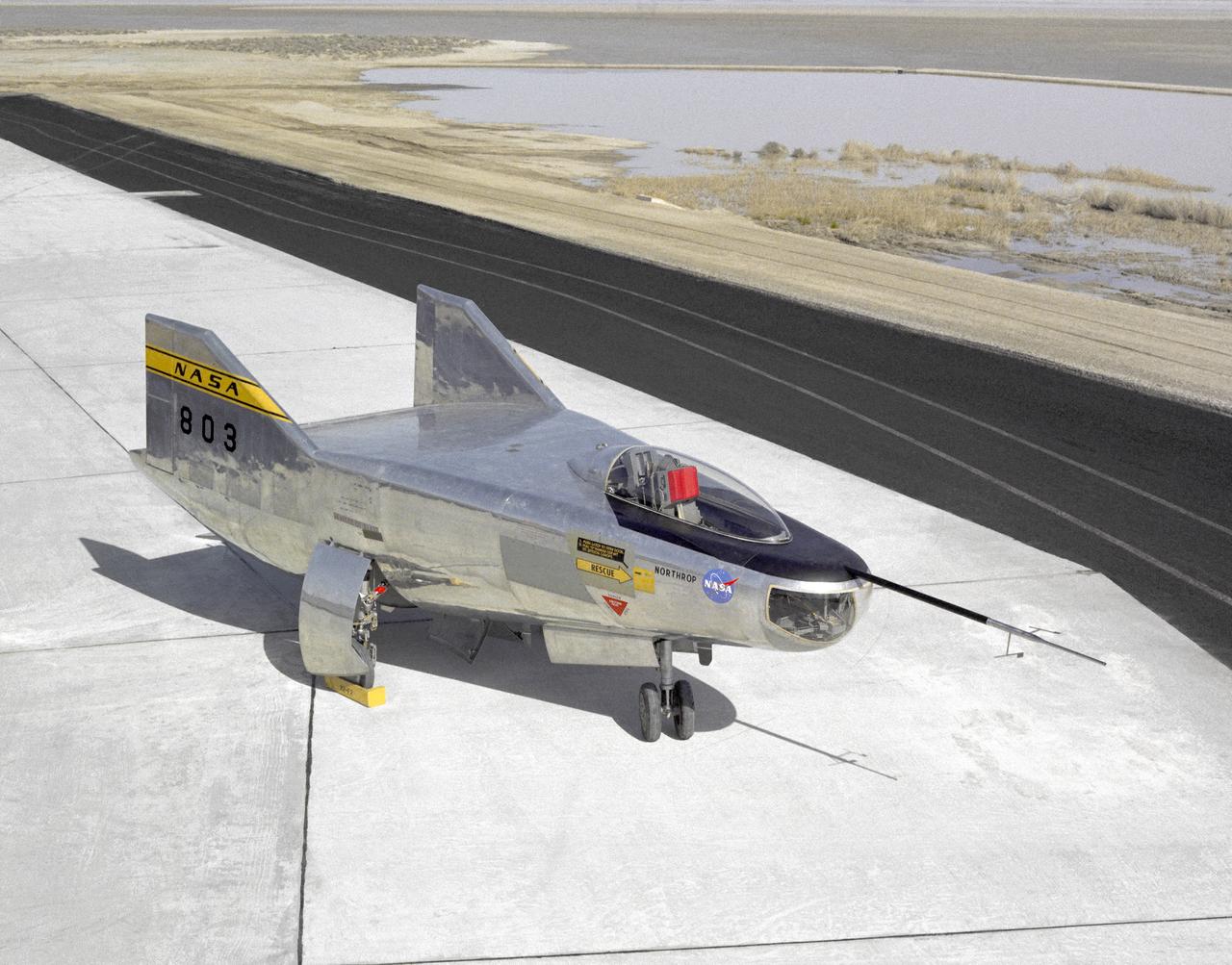 The M2-F2 Lifting Body is seen here on the ramp at the NASA Dryden Flight Research Center. The success of Dryden's M2-F1 program led to NASA's development and construction of two heavyweight lifting bodies based on studies at NASA's Ames and Langley research centers -- the M2-F2 and the HL-10, both built by the Northrop Corporation. The "M" refers to "manned" and "F" refers to "flight" version. "HL" comes from "horizontal landing" and 10 is for the tenth lifting body model to be investigated by Langley.  The first flight of the M2-F2 -- which looked much like the "F1" -- was on July 12, 1966. Milt Thompson was the pilot. By then, the same B-52 used to air launch the famed X-15 rocket research aircraft was modified to also carry the lifting bodies. Thompson was dropped from the B-52's wing pylon mount at an altitude of 45,000 feet on that maiden glide flight.  The M2-F2 weighed 4,620 pounds, was 22 feet long, and had a width of about 10 feet.  On May 10, 1967, during the sixteenth glide flight leading up to powered flight, a landing accident severely damaged the vehicle and seriously injured the NASA pilot, Bruce Peterson.  NASA pilots and researchers realized the M2-F2 had lateral control problems, even though it had a stability augmentation control system. When the M2-F2 was rebuilt at Dryden and redesignated the M2-F3, it was modified with an additional third vertical fin -- centered between the tip fins -- to improve control characteristics.  The M2-F2/F3 was the first of the heavy-weight, entry-configuration lifting bodies. Its successful development as a research test vehicle answered many of the generic questions about these vehicles.  NASA donated the M2-F3 vehicle to the Smithsonian Institute in December 1973. It is currently hanging in the Air and Space Museum along with the X-15 aircraft number 1, which was its hangar partner at Dryden from 1965 to 1969.