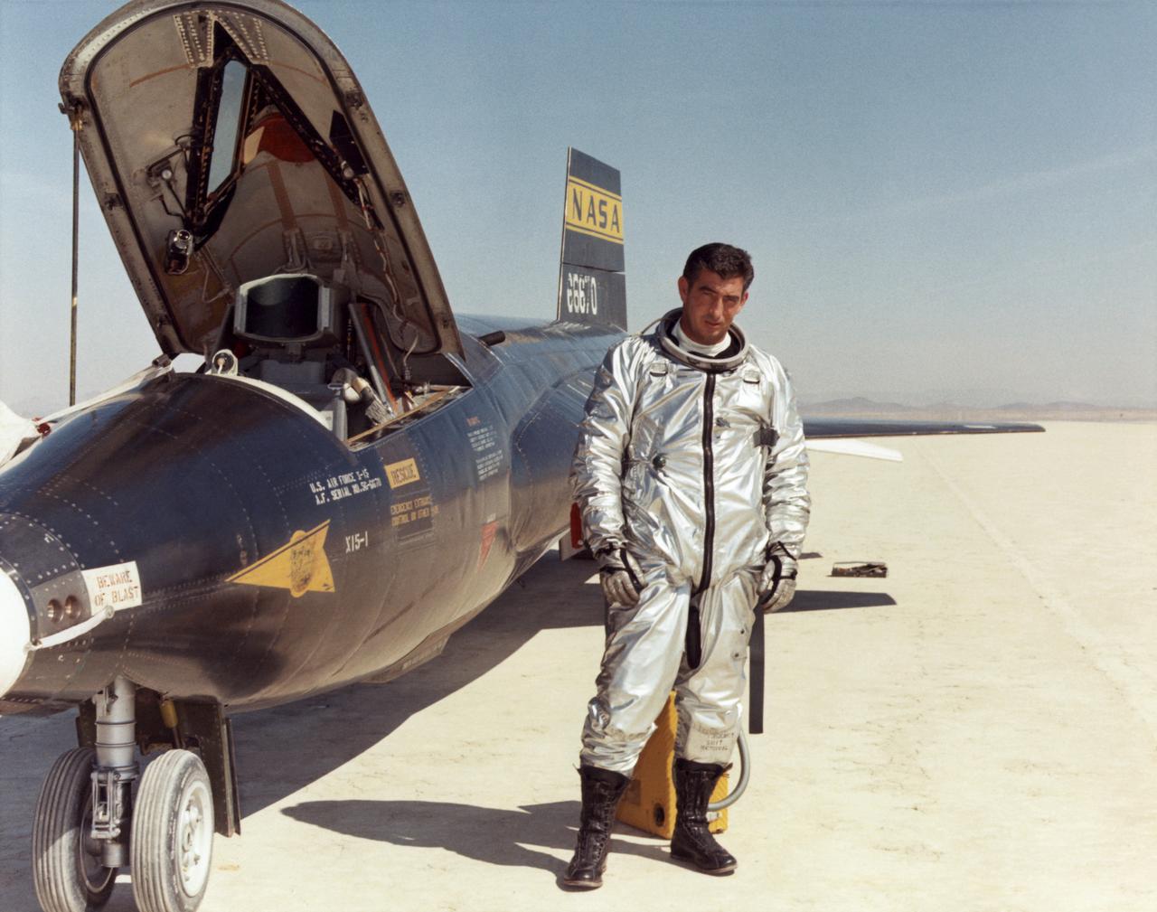 Air Force test pilot Maj. Michael J. Adams stands beside X-15 ship number one. Adams was selected for the X-15 program in 1966 and made his first flight on Oct. 6, 1966. On Nov. 15, 1967, Adams made his seventh and final X-15 flight. The X-15 launched from the B-52, but during the ascent an electrical problem affected the X-15's control system. The aircraft crashed northwest of Cuddeback Lake, California, causing the death of Adams.  He was posthumously awarded Air Force astronaut wings because his final flight exceeded 50 miles in altitude. Adams was the only pilot lost in the 199-flight X-15 program.