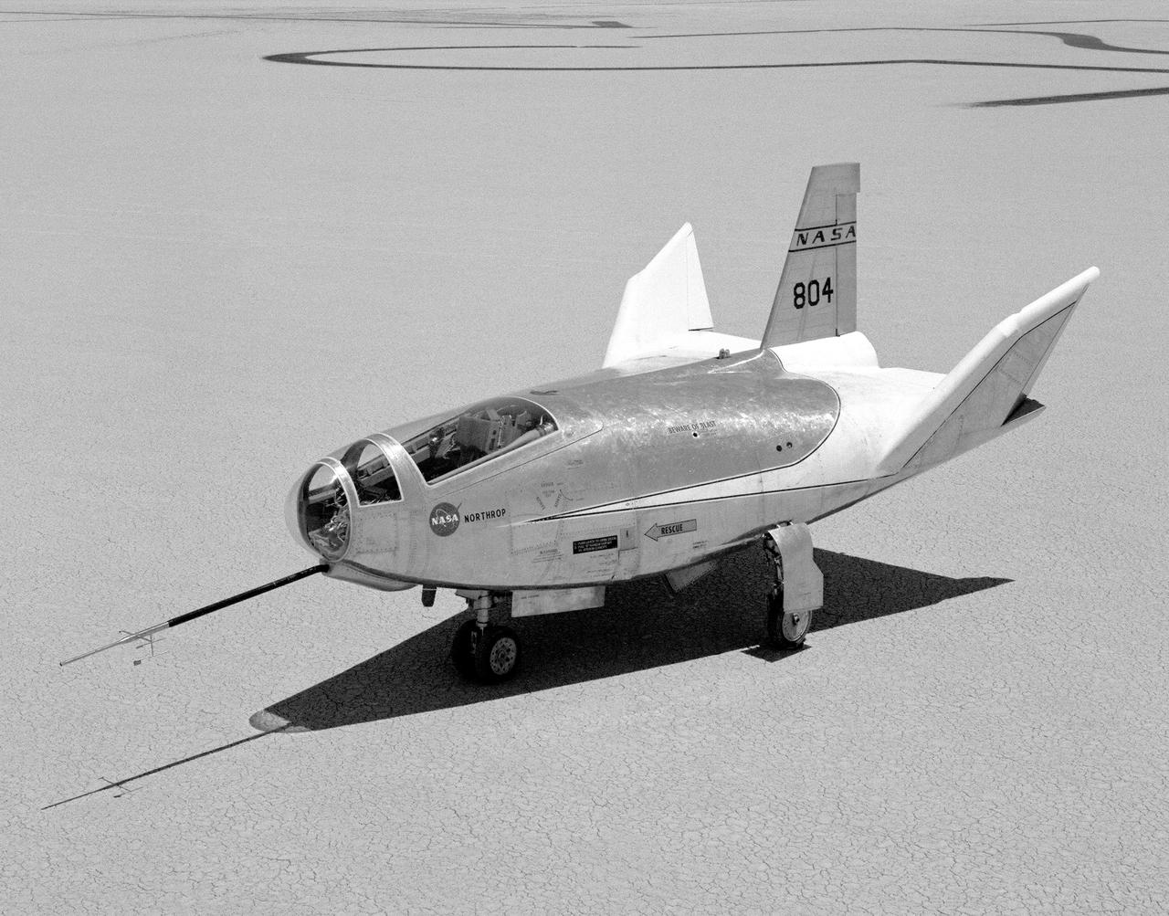 The HL-10 Lifting Body is seen here parked on Rogers Dry Lake, the unique location where it landed after research flights. This 1968 photo shows the vehicle after the fins were modified to remove instabilities encountered on the first flight. It involved a change to the shape of the leading edge of the fins to eliminate flow separation. It required extensive wind-tunnel testing at Langley Research Center, Hampton, Va. NASA Flight Research Center (FRC) engineer Bob Kempel than plotted thousands of data points by hand to come up with the modification, which involved a fiberglass glove backed with a metal structure on each fin's leading edge. This transformed the vehicle from a craft that was difficult to control into the best handling of the original group of lifting bodies at the FRC.