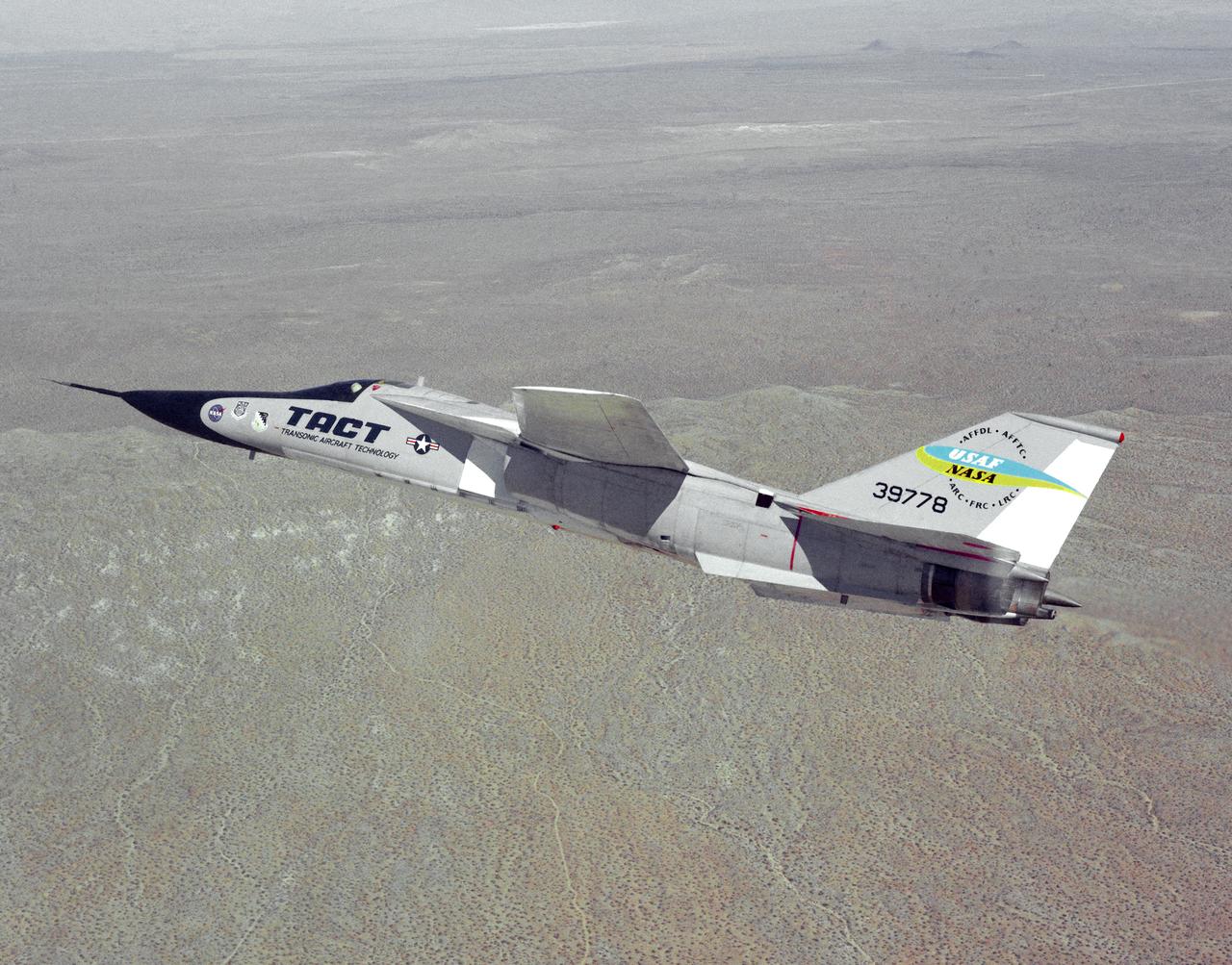 The General Dynamics TACT/F-111A Aardvark is seen In a banking-turn over the California Mojave desert. This photograph affords a good view of the supercritical wing airfoil shape.  Starting in 1971 the NASA Flight Research Center and the Air Force undertook a major research and flight testing program, using F-111A (#63-9778), which would span almost 20 years before completion. Intense interest over the results coming from the NASA F-8 supercritical wing program spurred NASA and the Air Force to modify the General Dynamics F-111A to explore the application of supercritical wing technology to maneuverable military aircraft. This flight program was called Transonic Aircraft Technology (TACT).