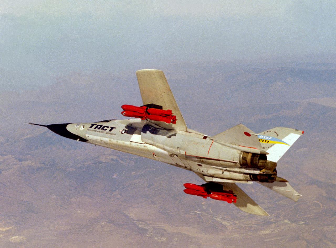 The General Dynamics TACT/F-111A (Serial #63-9778) banks over the Mojave Desert. Note the fully loaded racks of inert pratice bombs which were carried for weapon loads evaluations on the supercritical wing (SCW) that was the main feature of the Transonic Aircraft Technology F-111 research program. Intense interest in the results of the earlier F-8 SCW program spurred NASA and the U.S. Air Force to modify the number 13 F-111A for the TACT program. This aircraft participated in a major research and flight testing program that spanned nearly 20 years, beginning in 1971 at the NASA Flight Research Center at Edwards AFB, California.