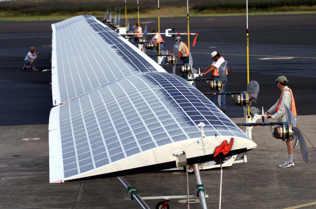Ground crewmen maneuver AeroVironment's solar-powered Helios Prototype flying wing on its ground support dolly during functional checkouts prior to its first flights under solar power from the U.S. Navy's Pacific Missile Range Facility on Kaua'i, Hawaii.