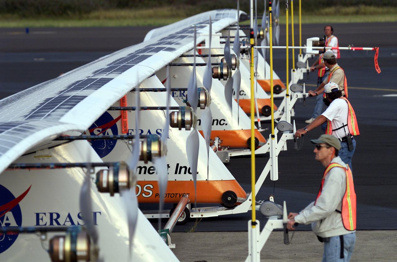 Ground crewmen maneuver AeroVironment's solar-powered Helios Prototype flying wing on its ground support dolly during functional checkouts prior to its first flights under solar power from the U.S. Navy's Pacific Missile Range Facility on Kaua'i, Hawaii.