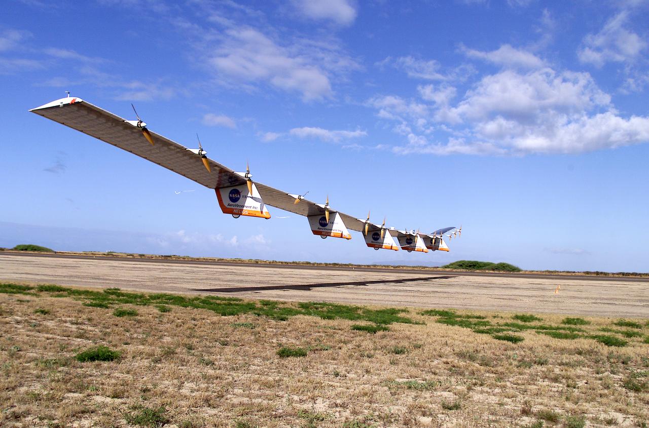 The solar-electric Helios Prototype flying wing is shown moments after takeoff, beginning its first test flight on solar power from the U.S. Navy's Pacific Missile Range Facility on Kauai, Hawaii, July 14, 2001. The 18-hour flight was a functional checkout of the aircraft's systems and performance in preparation for an attempt to reach sustained flight at 100,000 feet altitude later this summer.