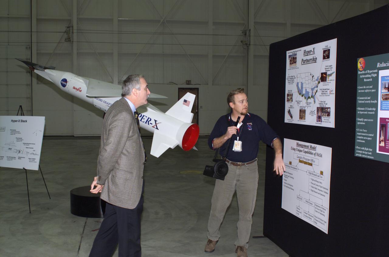 NASA Administrator Sean O'Keefe left, learned about the Mach 10 X-43 research vehicle from manager, Joel Sitz during O'Keefe's visit to the NASA Dryden Flight Research Center, Edwards, California, January 31, 2002.