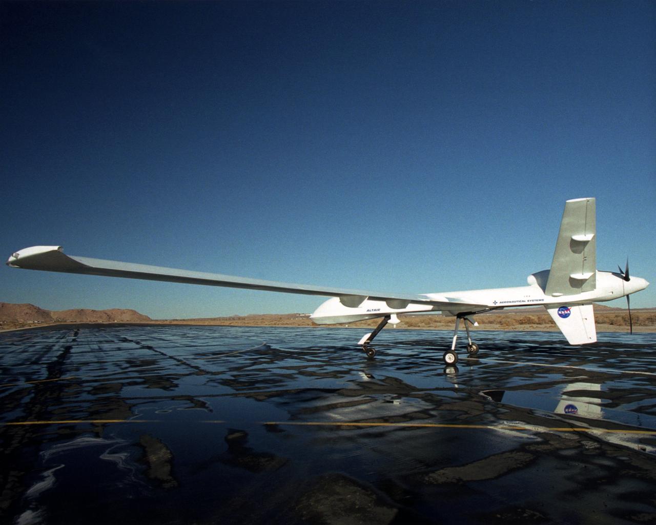 Long wings, a V-tail with a ventral  fin and a rear-mounted engine distinguish the Altair, an unmanned aerial vehicle built for NASA by General Atomics Aeronautical Systems, Inc.