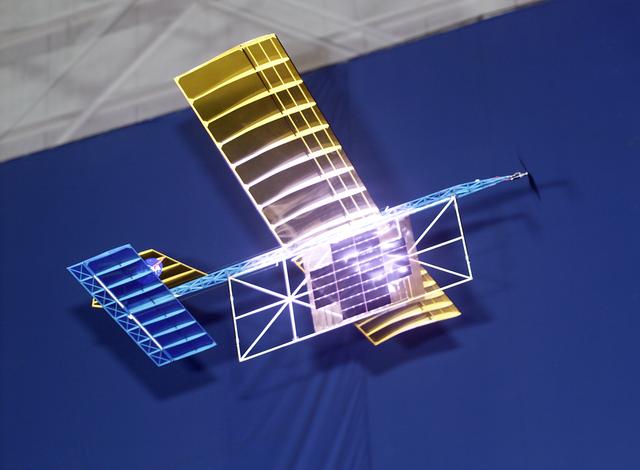 NASA image: With a laser beam centered on its panel of photovoltaic cells, a model plane makes the first flight of an aircraft powered by a laser beam inside a building at NASA Marshall.