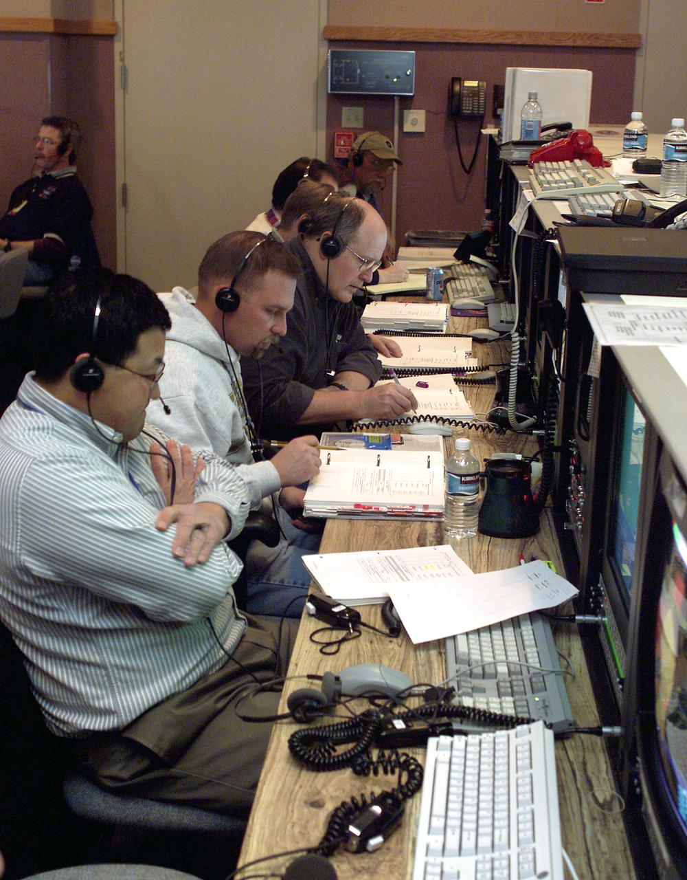 Engineers and technicians in the control room at the Dryden Flight Research Center must constantly monitor critical operations and checks during research projects like NASA's hypersonic X-43A. Visible in the photo, taken two days before the X-43's captive carry flight in January 2004, are [foreground to background]; Tony Kawano (Range Safety Officer), Brad Neal (Mission Controller), and Griffin Corpening (Test Conductor).