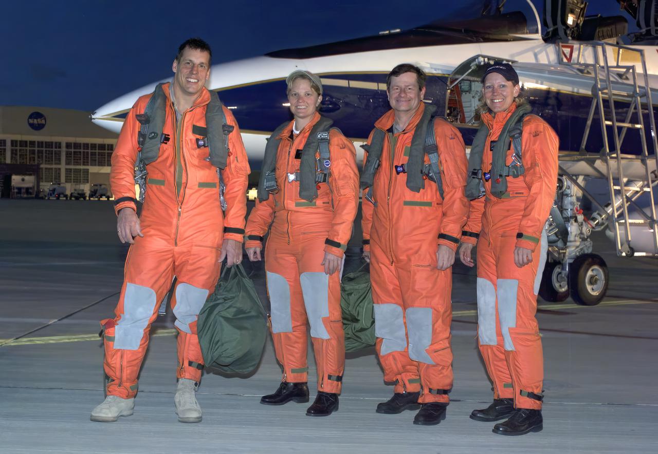 From left, pilot Craig Bomben, photographer Carla Thomas, pilot Frank Batteas, and videographer Lori Losey make up the flight crews for two F-18 high-performance jets to document a flight of NASA’s B-52B carrying a Pegasus booster rocket and the X-43A. A dry run, known as a captive carry mission, was conducted to monitor the research hardware in flight for any challenges. The January 2004 X-43A flight was based at NASA’s Armstrong Flight Research Center in Edwards, California.