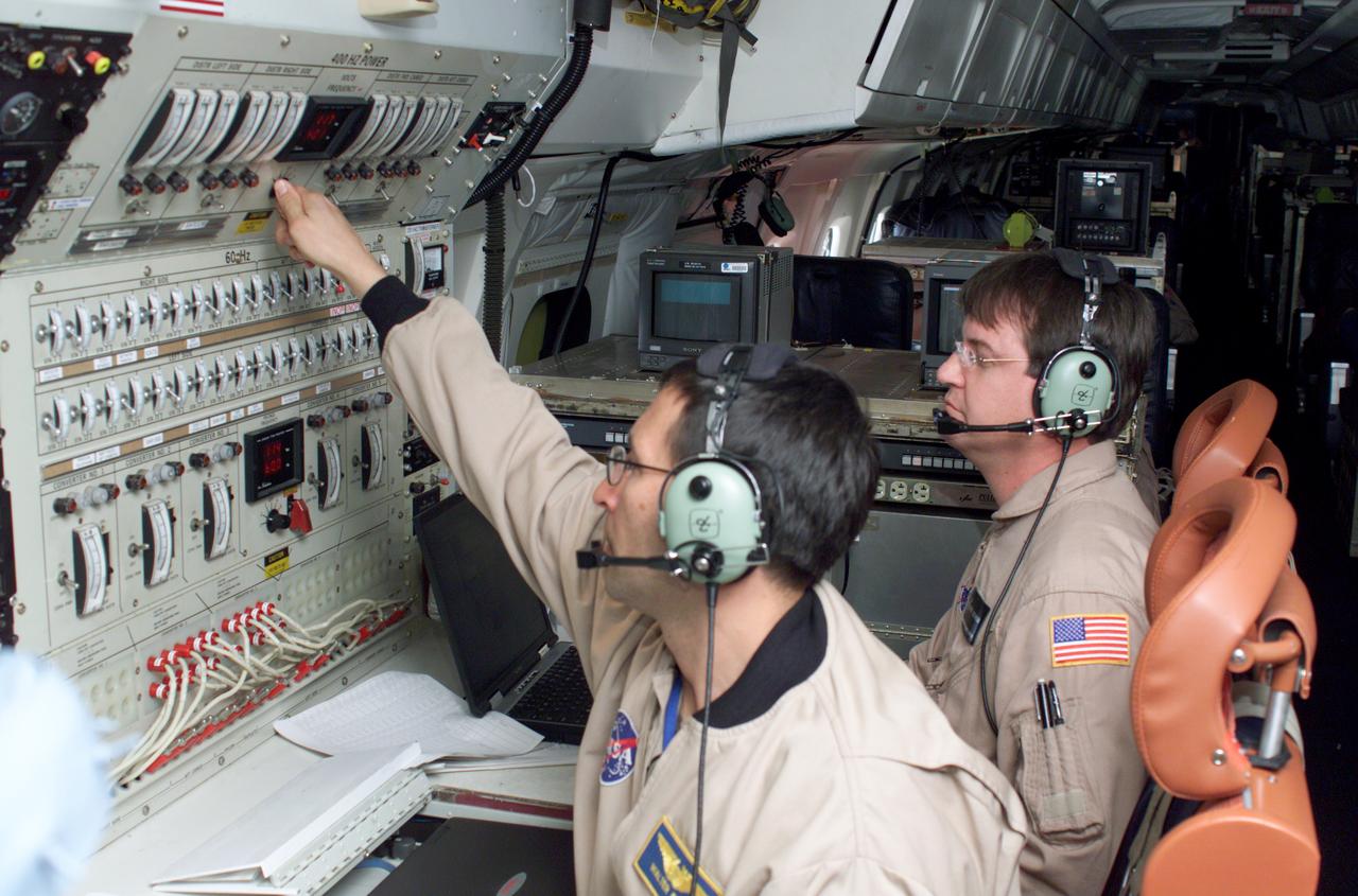 Airborne Science personnel Walter Klein and David Bushman at the Mission Manager's console onboard NASA's DC-8 during the AirSAR 2004 campaign. AirSAR 2004 is a three-week expedition by an international team of scientists that will use an all-weather imaging tool, called the Airborne Synthetic Aperture Radar (AirSAR), in a mission ranging from the tropical rain forests of Central America to frigid Antarctica.