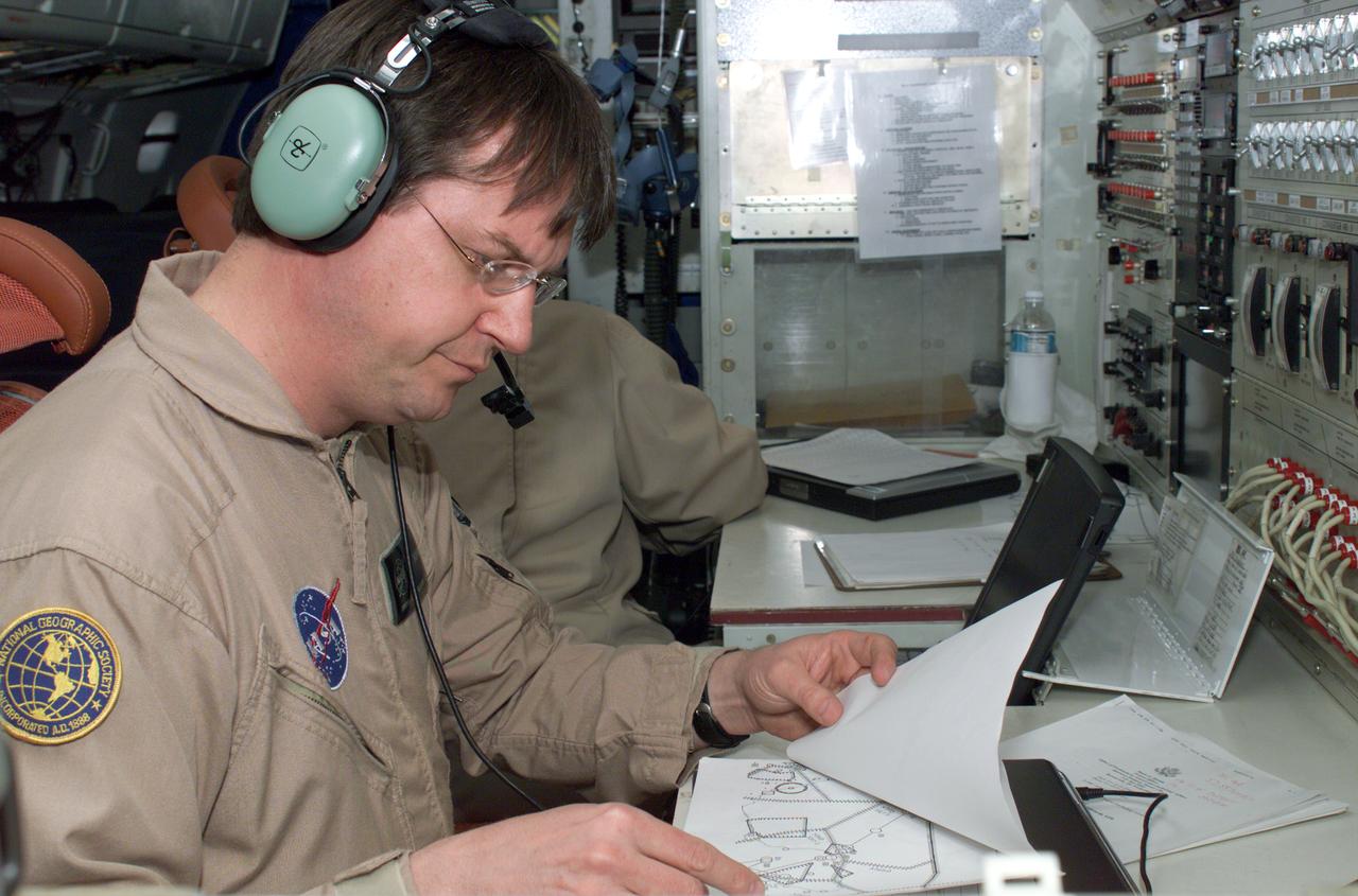 David Bushman at the Mission Manager's console onboard NASA's DC-8 during the AirSAR 2004 campaign. AirSAR 2004 is a three-week expedition by an international team of scientists that will use an all-weather imaging tool, called the Airborne Synthetic Aperture Radar (AirSAR), in a mission ranging from the tropical rain forests of Central America to frigid Antarctica.