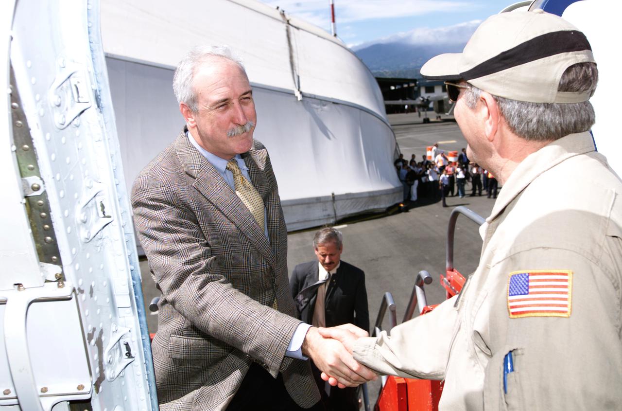 Dr. Tom Mace, NASA DFRC Director of Airborne Sciences, greets NASA Administrator Sean O'Keefe as he enters the DC-8 aircraft during a stop-off on the AirSAR 2004 Mesoamerica campaign. AirSAR 2004 Mesoamerica is a three-week expedition by an international team of scientists that will use an all-weather imaging tool, called the Airborne Synthetic Aperture Radar (AirSAR), in a mission ranging from the tropical rain forests of Central America to frigid Antarctica.