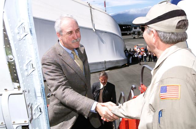 NASA image: Dr. Tom Mace, DFRC Director of Airborne Sciences, greets NASA Administrator Sean O'Keefe as he enters the DC-8 aircraft during a stop-off on the AirSAR 2004 campaign