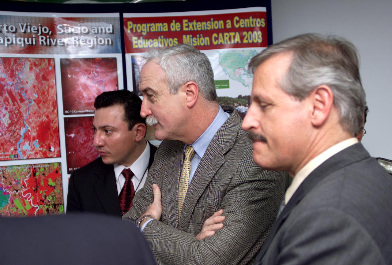 L-R; Jorge Andres Diaz, Director of the Costa Rican National Hangar for Airborne Research division of the National Center for High Technology(CENAT); NASA Administrator Sean O'Keefe; and Fernando Gutierrez, Costa Rican Minister of Science and Technology(MICIT), viewing posters showing how NASA activities have made an impact on Costa Rican people. Mr. O'Keefe was in Costa Rica to participate in the AirSAR 2004 Mesoamerica campaign, which used NASA DFRC's DC-8 airborne laboratory aircraft. AirSAR 2004 is a three-week expedition by an international team of scientists that will use an all-weather imaging tool, called the Airborne Synthetic Aperture Radar (AirSAR), in a mission ranging from the tropical rain forests of Central America to frigid Antarctica.