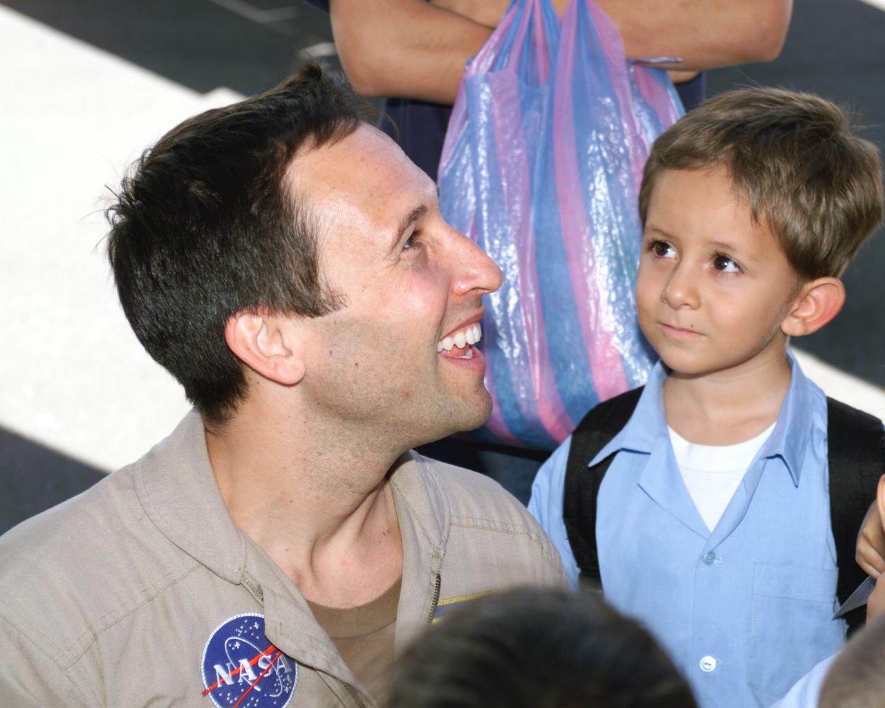 NASA Dryden Mission Manager Walter Klein passes out Airborne Science stickers and lithographs to underprivileged school children that visited the airport on Monday March 8, 2004. In spanish, he explained to them the mission of the DC-8 AirSAR 2004 Mesoamerican campaign in Costa Rica. AirSAR 2004 Mesoamerica is a three-week expedition by an international team of scientists that uses an all-weather imaging tool, called the Airborne Synthetic Aperture Radar (AirSAR) which is located onboard NASA's DC-8 airborne laboratory.  Scientists from many parts of the world including NASA's Jet Propulsion Laboratory are combining ground research done in several areas in Central America with NASA's AirSAR technology to improve and expand on the quality of research they are able to conduct.  The radar, developed by NASA's Jet Propulsion Laboratory, can penetrate clouds and also collect data at night. Its high-resolution sensors operate at multiple wavelengths and modes, allowing AirSAR to see beneath treetops, through thin sand, and dry snow pack.  AirSAR's 2004 campaign is a collaboration of many U.S. and Central American institutions and scientists, including NASA; the National Science Foundation; the Smithsonian Institution; National Geographic; Conservation International; the Organization of Tropical Studies; the Central American Commission for Environment and Development; and the Inter-American Development Bank.