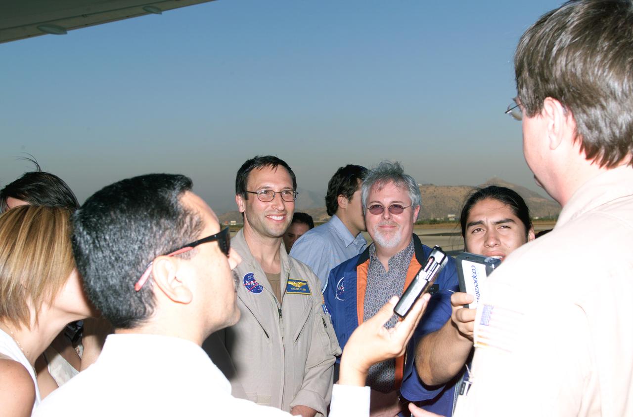 L to R; NASA Dryden Mission Manager Walter Klein (in tan flight suit), JPL AirSAR Scientist Tim Miller, and Mission Manager David Bushman briefing press in Santiago, Chile, for NASA's AirSAR 2004 mission. AirSAR 2004 is a three-week expedition by an international team of scientists that uses an all-weather imaging tool, called the Airborne Synthetic Aperture Radar (AirSAR) which is located onboard NASA's DC-8 airborne laboratory. Scientists from many parts of the world including NASA's Jet Propulsion Laboratory are combining ground research done in several areas in Central and South America with NASA's AirSAR technology to improve and expand on the quality of research they are able to conduct. In South America and Antarctica, AirSAR collected imagery and data to help determine the contribution of Southern Hemisphere glaciers to sea level rise due to climate change. In Patagonia, researchers found this contribution had more than doubled from 1995 to 2000, compared to the previous 25 years. AirSAR data will make it possible to determine whether that trend is continuing or accelerating. AirSAR will also provide reliable information on ice shelf thickness to measure the contribution of the glaciers to sea level.