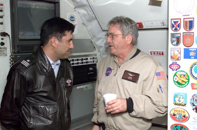 NASA image: Chilean Air Force Captain Saez and Dr. Tom Mace discuss airborne science during a DC-8 ferry flight from Santiago to Punta Arenas, Chile