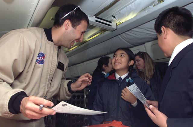 NASA image: NASA Dryden Mission Manager Walter Klein talks with school children from Punta Arenas, Chile, during a tour of the DC-8 aircraft