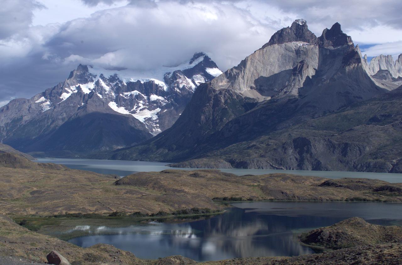 The Cuernos del Paine mountains in Torres del Paine National Park, Chile, during NASA's AirSAR 2004 campaign. AirSAR 2004 is a three-week expedition in Central and South America by an international team of scientists that is using an all-weather imaging tool, called the Airborne Synthetic Aperture Radar (AirSAR), located onboard NASA's DC-8 airborne laboratory. Scientists from many parts of the world are combining ground research with NASA's AirSAR technology to improve and expand on the quality of research they are able to conduct. Founded in 1959, Torres del Paine National Park encompasses 450,000 acres in the Patagonia region of Chile. This region is being studied by NASA using a DC-8 equipped with an Airborne Synthetic Aperture Radar (AirSAR) developed by scientists from NASA’s Jet Propulsion Laboratory. This is a very sensitive region that is important to scientists because the temperature has been consistently rising causing a subsequent melting of the region’s glaciers. AirSAR will provide a baseline model and unprecedented mapping of the region. This data will make it possible to determine whether the warming trend is slowing, continuing or accelerating. AirSAR will also provide reliable information on ice shelf thickness to measure the contribution of the glaciers to sea level.