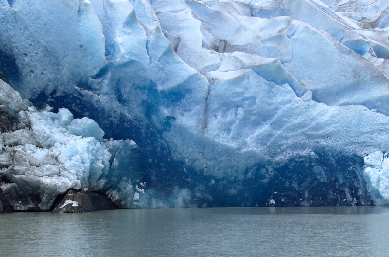 Close-up view of Grey Glacier from Lago Grey (Grey Lake), taken during NASA's AirSAR 2004 campaign in Chile. AirSAR 2004 is a three-week expedition in Central and South America by an international team of scientists that is using an all-weather imaging tool, called the Airborne Synthetic Aperture Radar (AirSAR), located onboard NASA's DC-8 airborne laboratory. Scientists from many parts of the world are combining ground research with NASA's AirSAR technology to improve and expand on the quality of research they are able to conduct. Founded in 1959, Torres del Paine National Park encompasses 450,000 acres in the Patagonia region of Chile. This region is being studied by NASA using a DC-8 equipped with an Airborne Synthetic Aperture Radar (AirSAR) developed by scientists from NASA’s Jet Propulsion Laboratory. This is a very sensitive region that is important to scientists because the temperature has been consistently rising causing a subsequent melting of the region’s glaciers. AirSAR will provide a baseline model and unprecedented mapping of the region. This data will make it possible to determine whether the warming trend is slowing, continuing or accelerating. AirSAR will also provide reliable information on ice shelf thickness to measure the contribution of the glaciers to sea level.