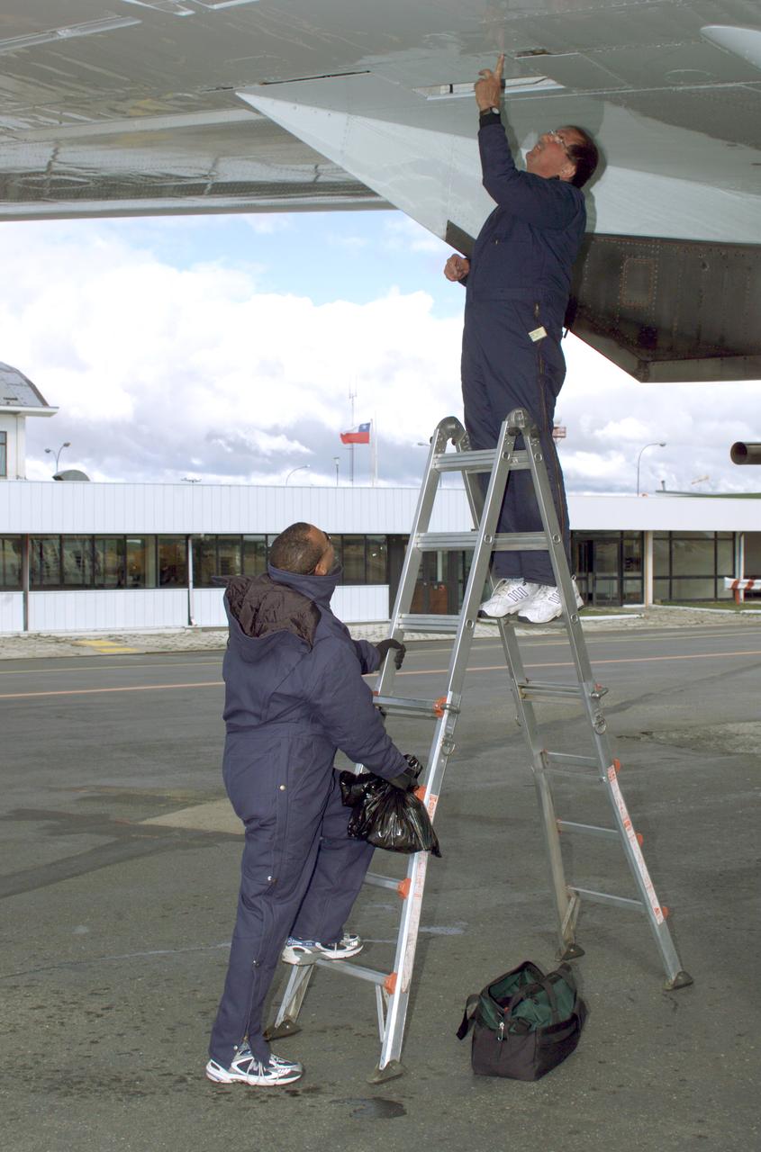 NASA DC-8 Ground Support Technicians Mark Corlew and Mike Lakowski perform routine maintenance on the aircraft at Carlos Ibanez del Campo International Airport in Punta Arenas, Chile. AirSAR 2004 is a three-week expedition by an international team of scientists that is using an all-weather imaging tool, called the Airborne Synthetic Aperture Radar (AirSAR) which is located onboard NASA's DC-8 airborne laboratory. Scientists from many parts of the world including NASA's Jet Propulsion Laboratory are combining ground research done in several areas in Central and South America with NASA's AirSAR technology to improve and expand on the quality of research they are able to conduct. In South America and Antarctica, AirSAR will collect imagery and data to help determine the contribution of Southern Hemisphere glaciers to sea level rise due to climate change. In Patagonia, researchers found this contribution had more than doubled from 1995 to 2000, compared to the previous 25 years. AirSAR data will make it possible to determine whether that trend is decreasing, continuing or accelerating. AirSAR will also provide reliable information on ice shelf thickness to measure the contribution of the glaciers to sea level.