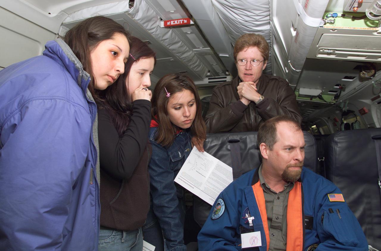 JPL scientist Dr. David Imel and U.S. Air Force Colonel Gwen Linde, the Defense Department Attache Officer assigned to the Chilean Embassy, lead Chilean students on a tour of the DC-8 aircraft at Carlos Ibanez del Campo International Airport in Punta Arenas, Chile. AirSAR 2004 is a three-week expedition by an international team of scientists that is using an all-weather imaging tool, called the Airborne Synthetic Aperture Radar (AirSAR) which is located onboard NASA's DC-8 airborne laboratory.  Scientists from many parts of the world including NASA's Jet Propulsion Laboratory are combining ground research done in several areas in Central and South America with NASA's AirSAR technology to improve and expand on the quality of research they are able to conduct.  In South America and Antarctica, AirSAR will collect imagery and data to help determine the contribution of Southern Hemisphere glaciers to sea level rise due to climate change. In Patagonia, researchers found this contribution had more than doubled from 1995 to 2000, compared to the previous 25 years. AirSAR data will make it possible to determine whether that trend is decreasing, continuing or accelerating. AirSAR will also provide reliable information on ice shelf thickness to measure the contribution of the glaciers to sea level.