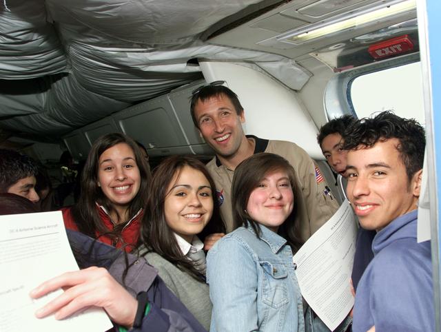 NASA image: NASA DC-8 Mission Manager Walter Klein poses with a group of Chilean Students onboard the aircraft in Punta Arenas, Chile