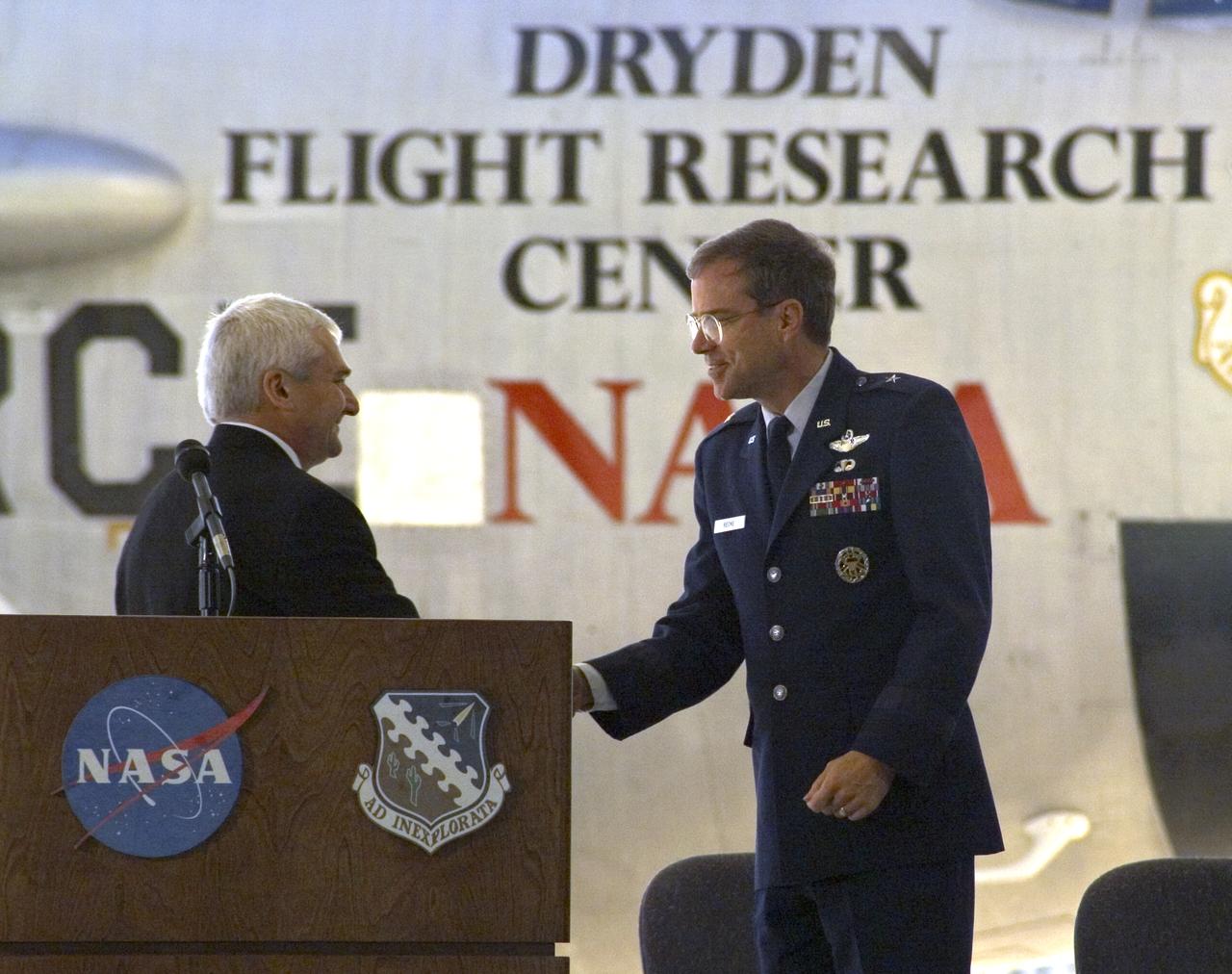 Dryden Center director Kevin Petersen shakes hands with AFFTC commander, Brig. Gen. Curtis Bedke, at the retirement ceremony for NASA's B-52B.